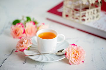 cup of tea with roses on a light background