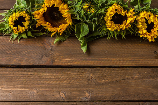 Sunflowers on wooden table. Bouquet.
