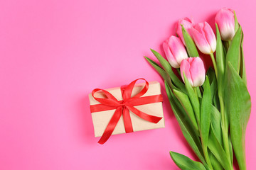 tulips and gifts on a pink background