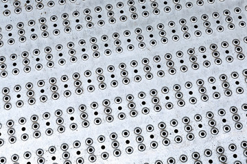 industrial background base metal with round holes many holes base design texture hard weathered