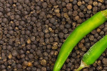 background decoration two green green chiles corner background black peppercorns copy space