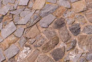 beige uneven asymmetric stones lime cemented part of the natural wall of the old castle gorada base design