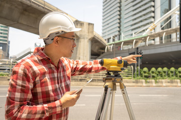 Civil engineer land survey with tacheometer or theodolite equipment. Worker Checking construction...