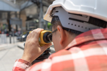 Civil engineer land survey with tacheometer or theodolite equipment. Worker Checking construction...