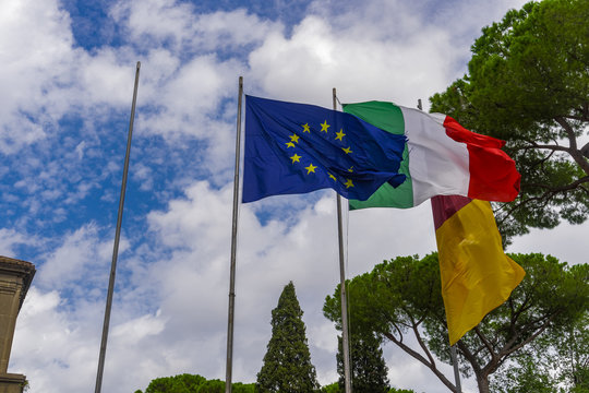 European Union, Italian and Rome flags waving. Flags flying on a mast at Capitoline Hill Rome, Italy.