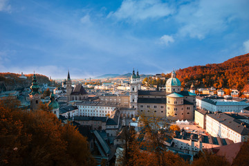Fototapeta na wymiar Beautiful of panoramic view in a Autumn season at a historic city of Salzburg , which Salzburg in a beautiful evening light with blue sky and colorful red and yellow of autumn,Salzburger Land, Austria
