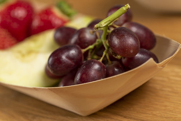 fresh grapes on bamboo bowl boat
