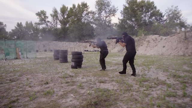 The security guards are trained to shoot guns at the shooting range.