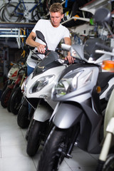 Fototapeta na wymiar Buyer man is choosing new motorcycle