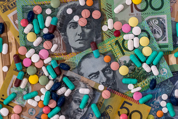Different dispersed pills on australian dollar banknotes