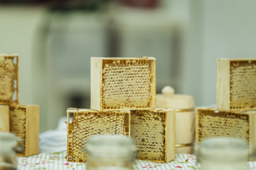 Assortment of different Honey in honeycombs. Gastronomic farm market counter, real scene