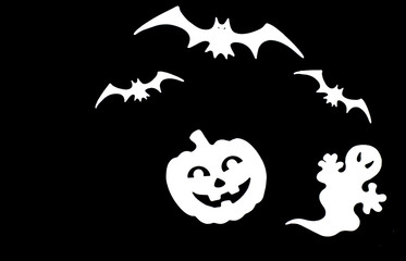 Close up white symbols of Halloween. Bats, pumpkin, ghost isolated on black background.