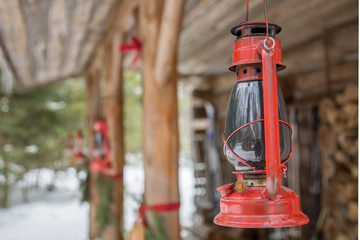 Fototapeta na wymiar Red Oil Lamp sitting outside of Cottage