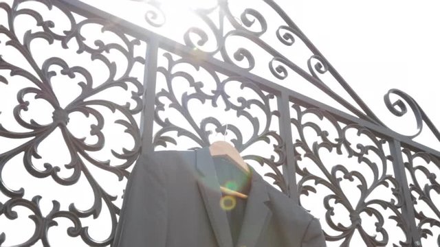Suit Jacket in sun on gate
