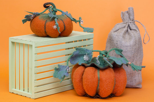 Still life with handmade pumpkins from felted wool for the celebration of Halloween