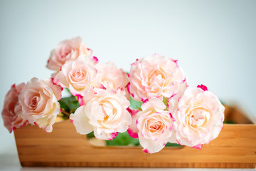 pink roses on a wooden tray