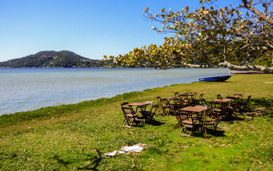 Florianopolis, Brazil - Circa August 2018: Restaurant tables at Lagoa da Conceicao, popular tourist destination in Florianopolis © Helissa
