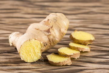 Ginger root on wooden table - Zingiber officinale