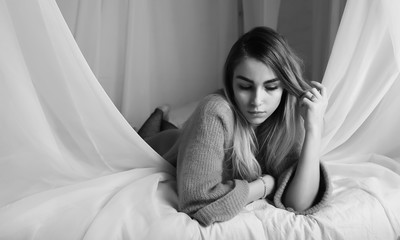 Young girl in a sweater in a room