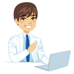 Young male doctor pointing blue ribbon movember concept with laptop