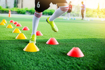 Kid soccer player moving speed test and Jogging and jump between marker