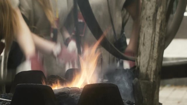 Female Blacksmiths turn Forging Wheel