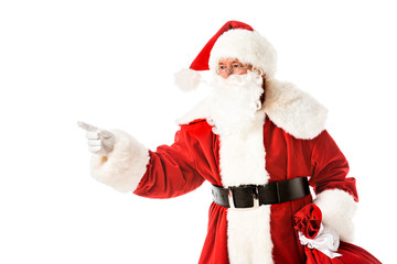 santa claus pointing on side while looking at camera isolated on white