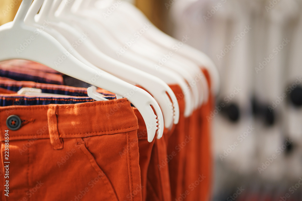 Wall mural Pants for boys on a hanger close-up. 