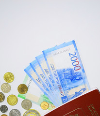 Foreign passport. Money from different countries.  Russian banknotes. Two thousand rubles. Metal ancient coins. Loose change. Travel credit. Preparation for a trip abroad.
