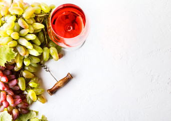 Grapes of Vine and Glass of Pink Wine on the White Background. Autumn mood.Copy space for Text.