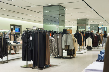 Modern fashion store. Buyers choose the right clothes.
