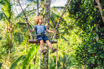 Naklejka na ściany i meble A boy on a swing over the jungle, Bali