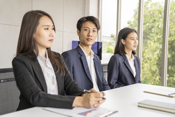 Asian business man meeting in office and look ot camera.