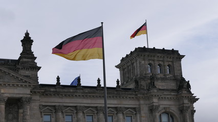 The German Bundestag building in Berlin with German flags