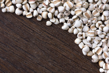 close up millet grain  on wooden table background. top view.