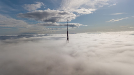 Naklejka na ściany i meble Riga Latvia Tv Tower Zakusala smoke clouds Europe biggest Aerial drone top view