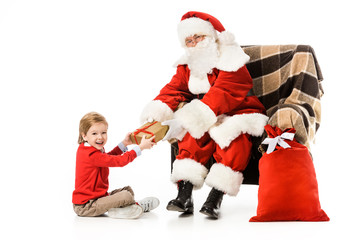 santa presenting christmas gift to excited little kid isolated on white