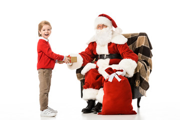 santa presenting christmas gift to excited kid isolated on white