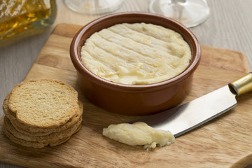 Brown bowl with soft Saint Marcellin cheese