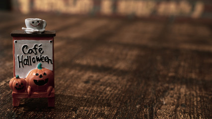Halloween festival Background. Halloween Pumpkins head with coffee cup on top and text cafe halloween decoration on wood background.