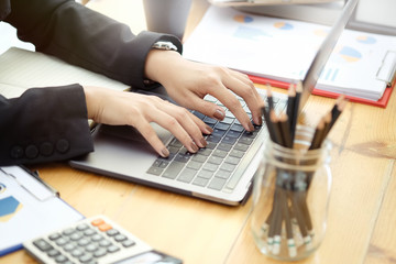 Businesswoman working on laptop in her office.