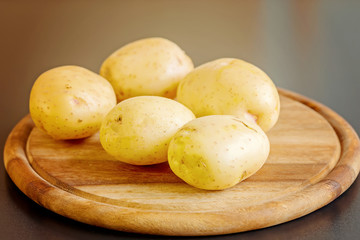 fresh potatoes on a wooden board
