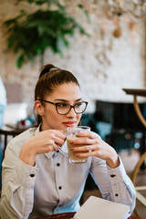 Daydreaming while drinking a hot drink in the cafe.