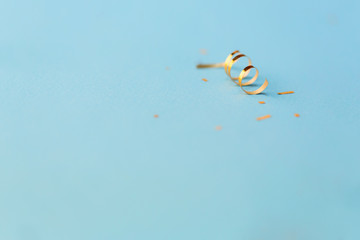 Golden confetti on blue background. copy space.