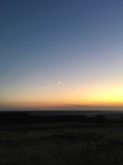 Fototapeta na wymiar moon, dramatic sunset over the field