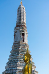 Golden Buddha Statue in front of a tall building in Wat Arun, Bangkok
