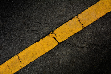 Yellow paint line on black asphalt. space transportation background