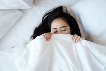 Woman sleeping in her bed