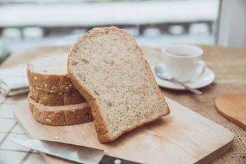 whole grain bread on wooden table morning meal with coffee vintage color tone