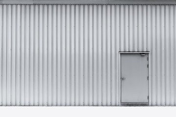 Industrial door on aluminium wall factory warehouse.